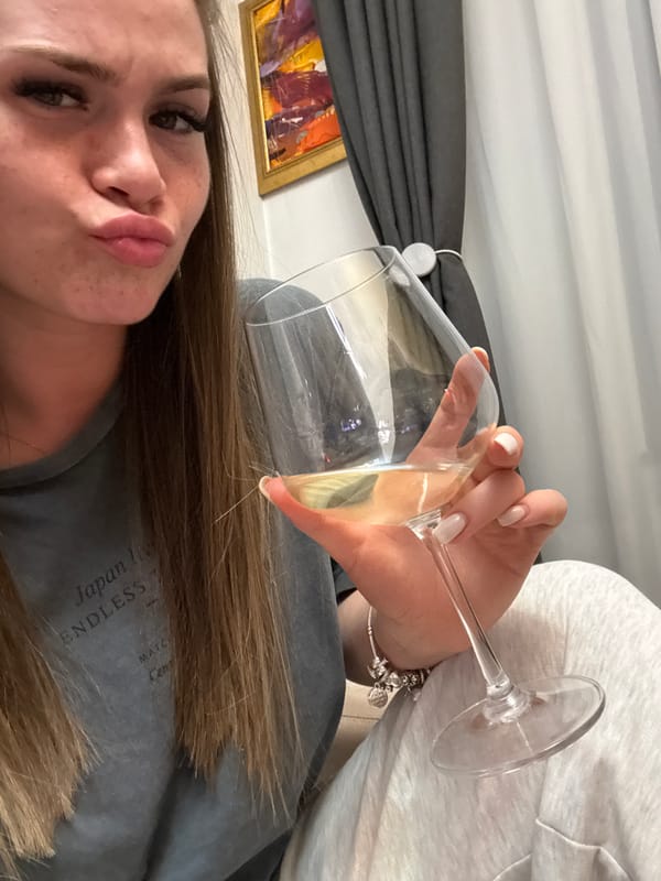Woman enjoys wine and snacks in Plovdiv apartment