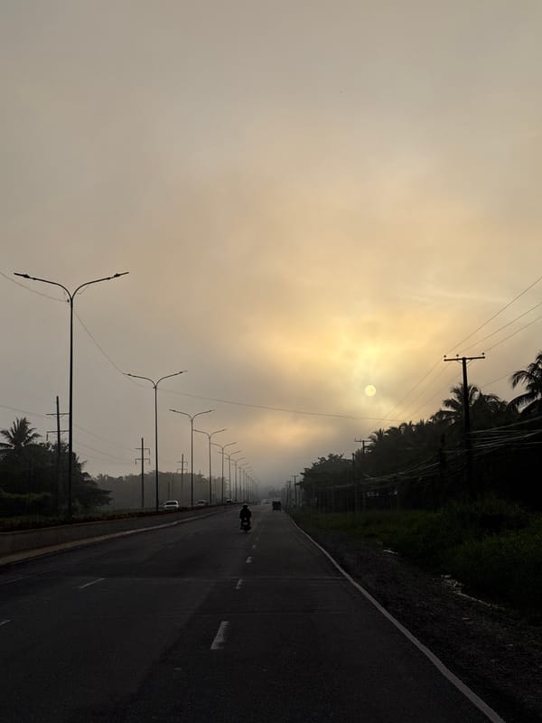 Hazy road scene at golden hour, Carmen, Philippines