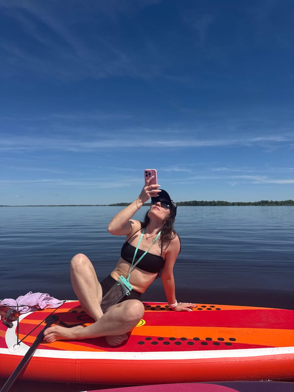 Women paddleboard on calm waters near Усть-Курдюм, Russia