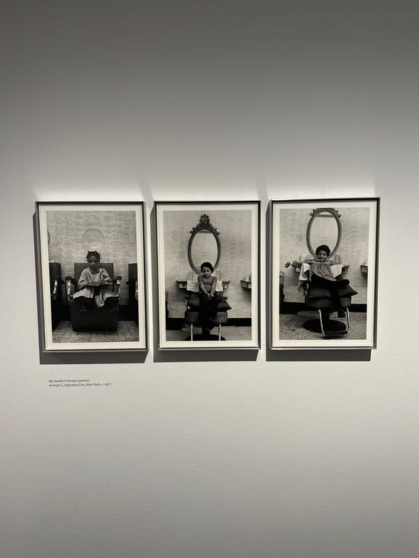 Three framed photos displayed vertically in London gallery space