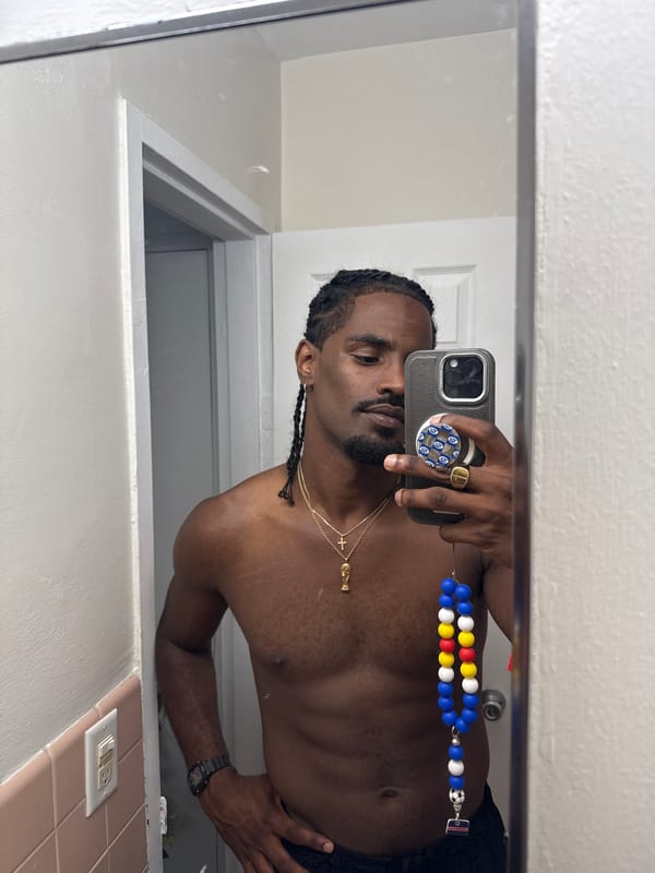 Bathroom mirror selfie with gold chain in Hollywood, FL