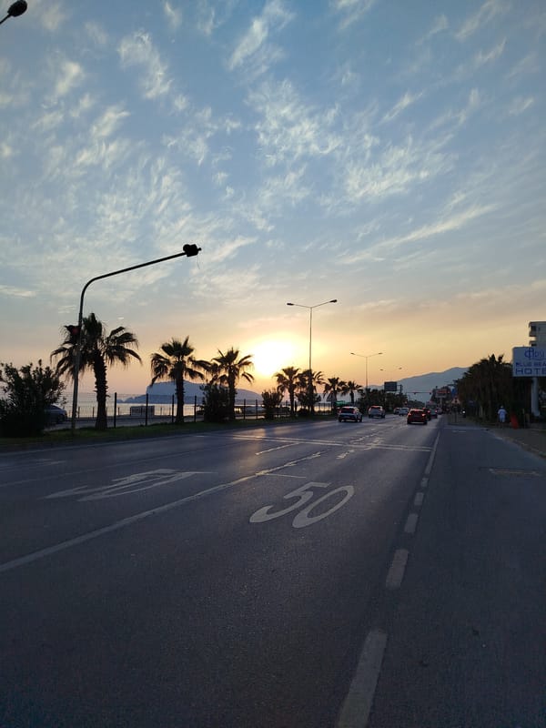 Sunset documented on palm-lined street in Alanya, Turkey
