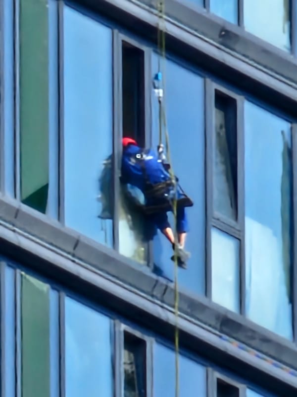 Rope-access work on a glass high-rise in Moscow