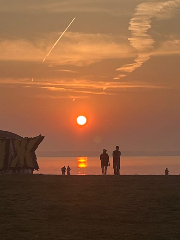 Sunset beach festival setup on the Surakovo shoreline