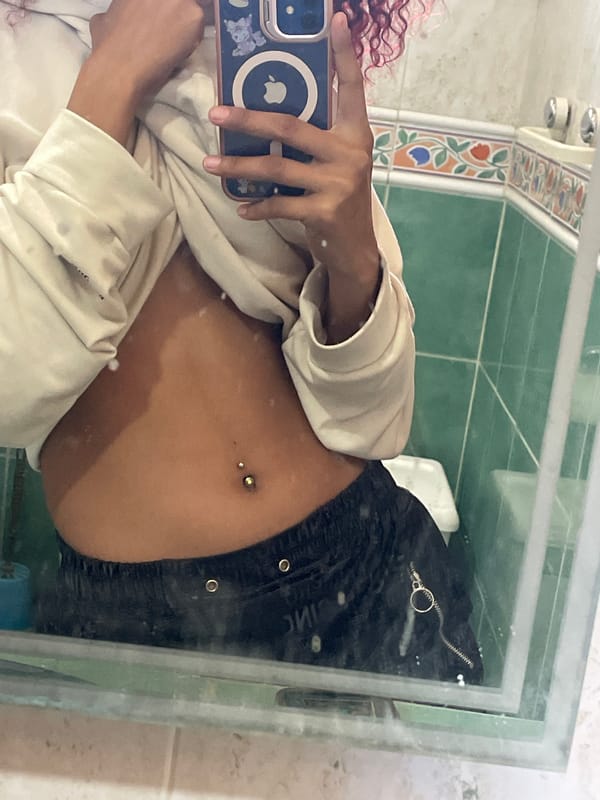 Person takes bathroom mirror selfie in Venezuela