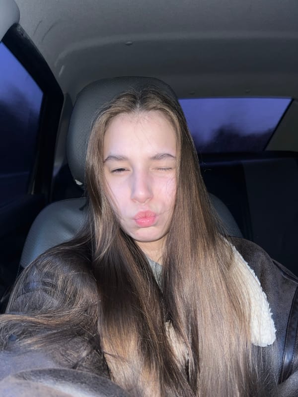 Woman rests in car back seat in Chaikovsky