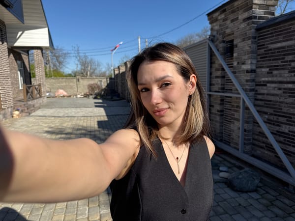 Woman takes selfies with Pomeranians in urban setting