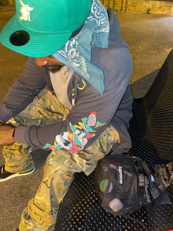 Man sits at illuminated Waltham Cross skatepark Friday evening