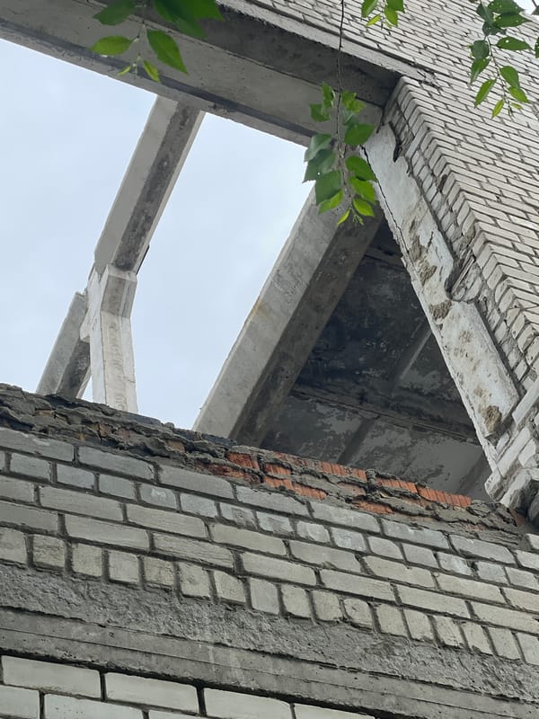 Abandoned building's decaying interior captured in upward view