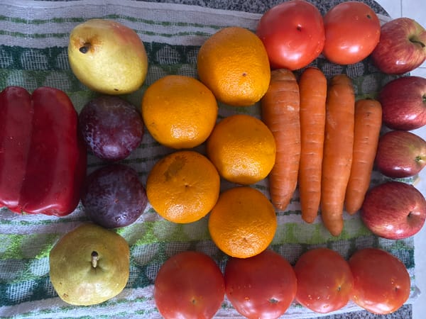 Fresh produce arranged on striped towel documented in Argentina