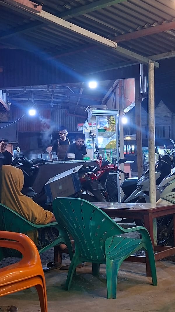 Night at a Keudegeudong warung, neon lights and street life
