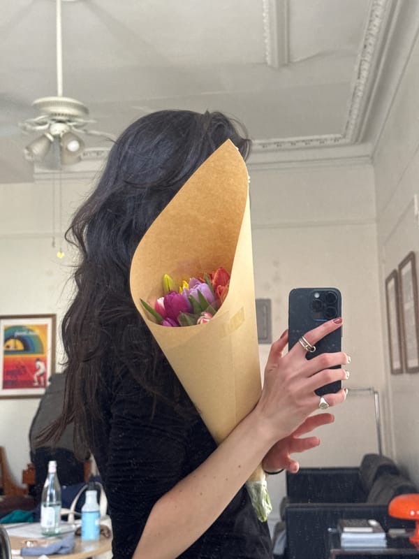 Woman Takes Mirror Selfies with Tulips in New York