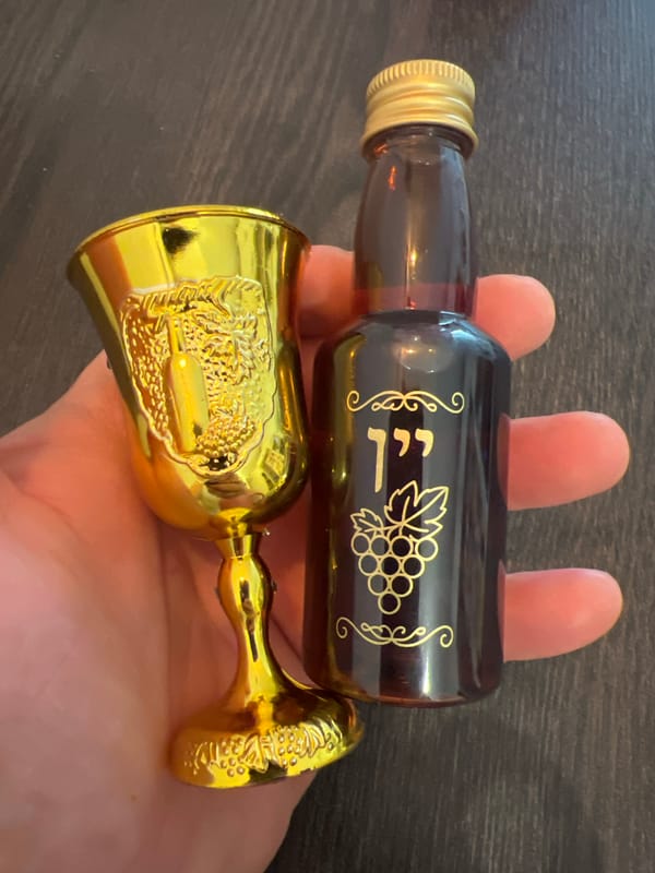 Individual displays amber bottle, golden goblet in Ramat Gan