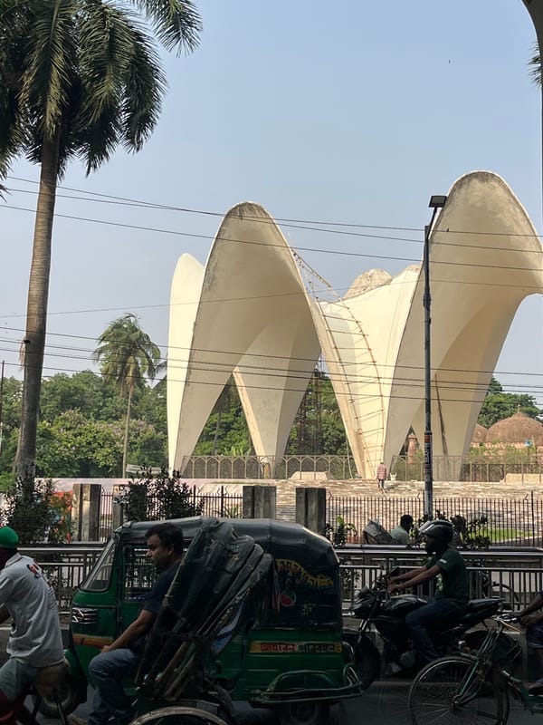 Morning street scene captured in Dhaka with motorcycle, architecture