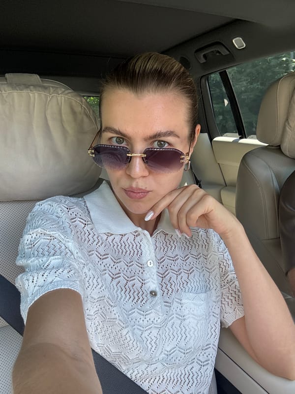 Car selfie in white lace top and sunglasses