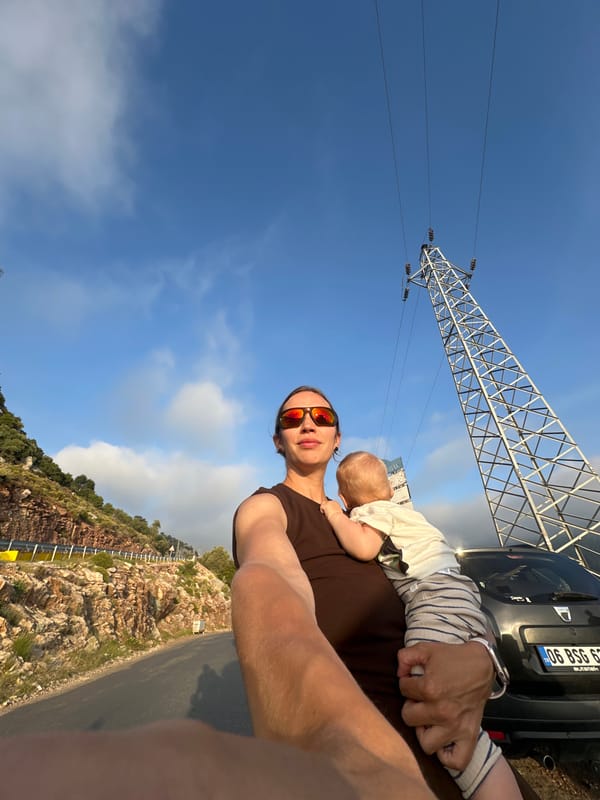 Person holds baby outdoors in Fethiye, Turkey