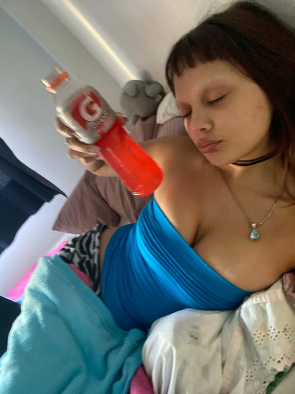 Woman rests with laptop in Buenos Aires bedroom