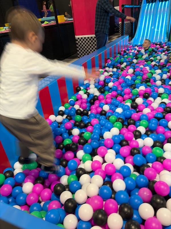 Child plays in colorful ball pit at Sofia indoor playground