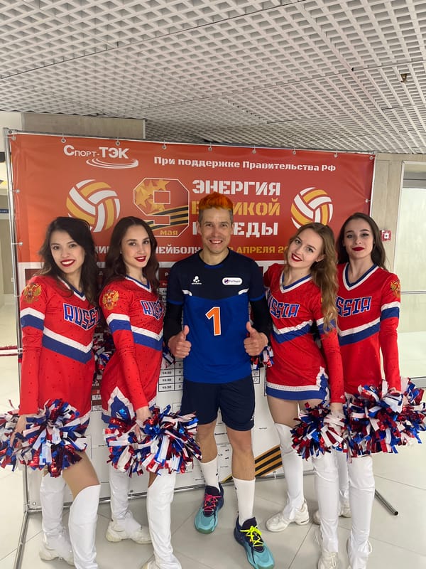 Cheerleaders pose with volleyball player in Moscow group photo