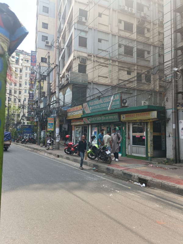 Morning street activity captured in Dhaka's Tikatuli commercial district