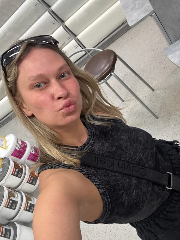 Woman shops for wallpaper in Perm hardware store