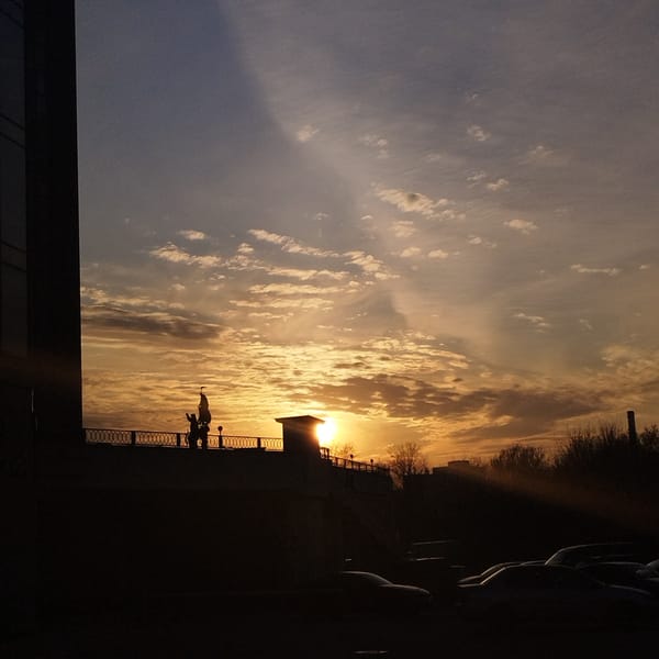 Sunset documented along Yekaterinburg riverbank with skyline views