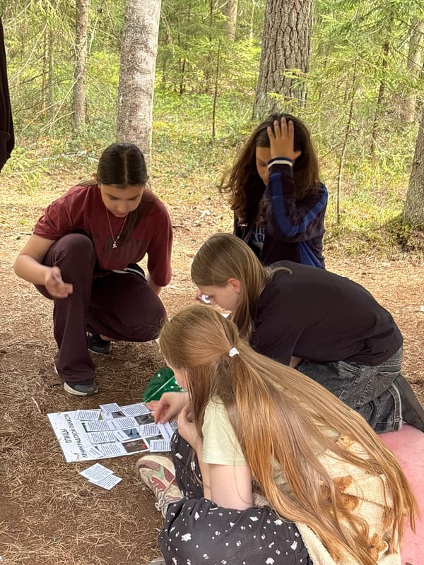 Young women gather for outdoor educational activity in Russian woods