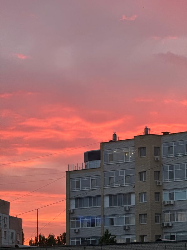 Vivid summer sunset over Saratov apartment rooftops
