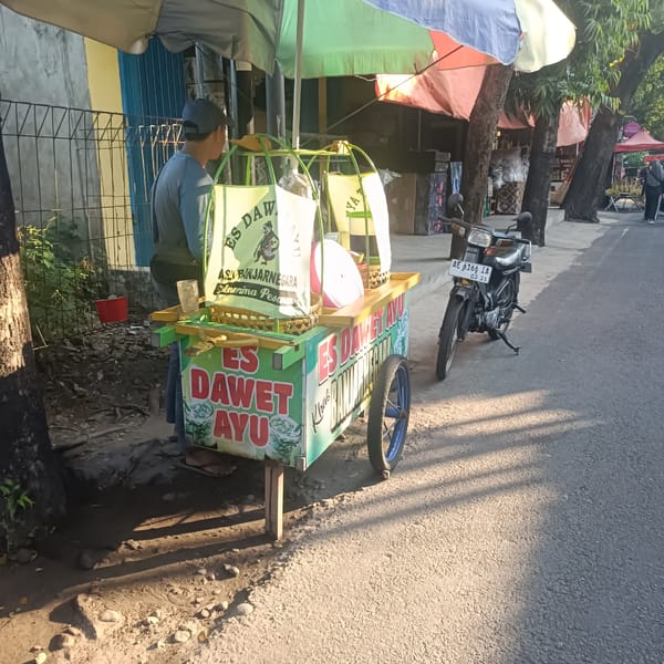 Street vendors operate diverse roadside markets in Madiun, Indonesia
