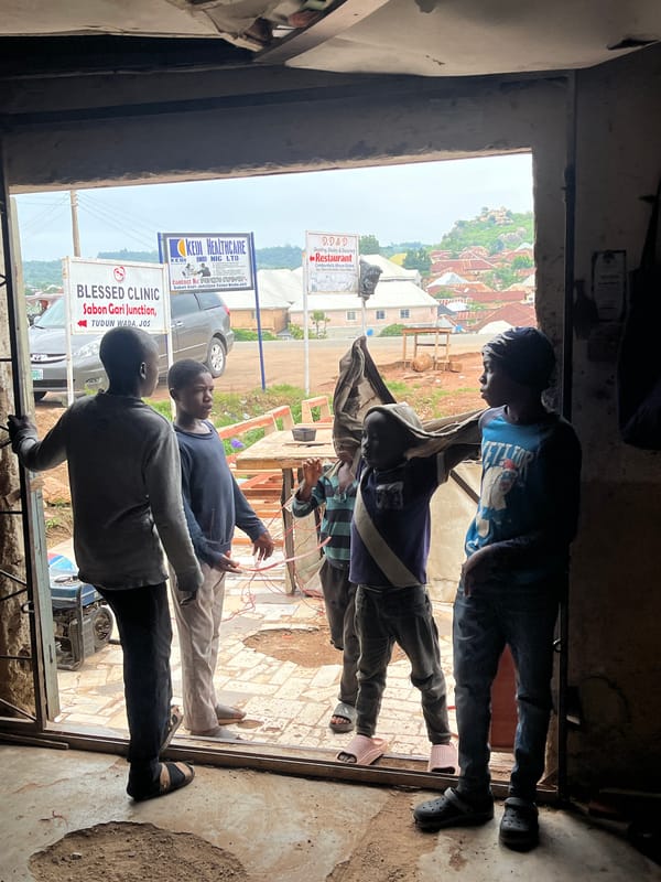 Street life and small commerce at a Jos, Nigeria corner