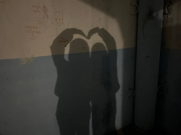 Heart shadow gesture captured on graffitied wall in Sosново