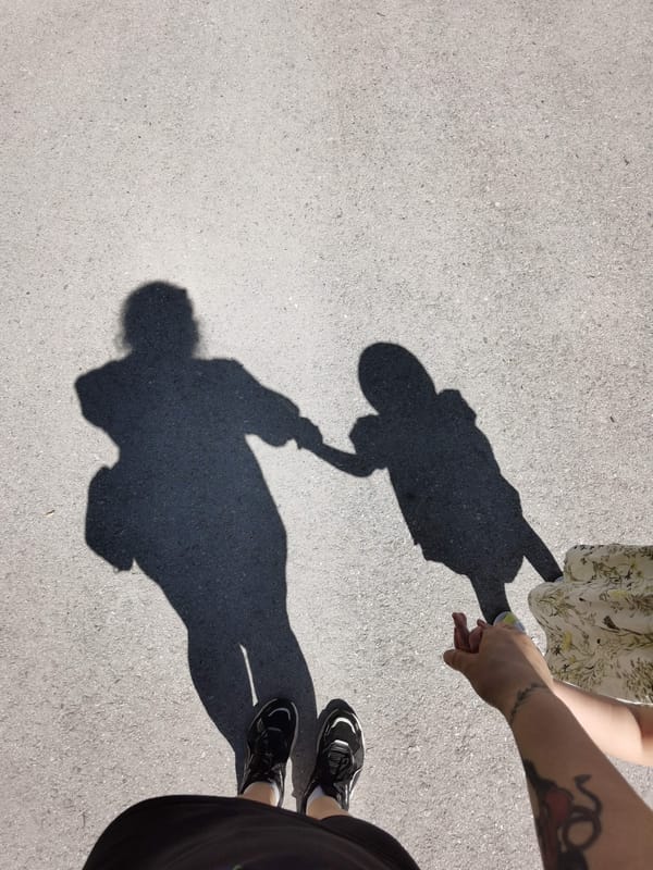 Adult and child share playful moment on Perm street