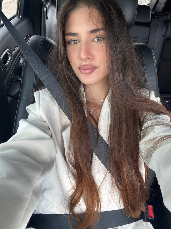 Woman in white jacket photographed in car, North Miami Beach