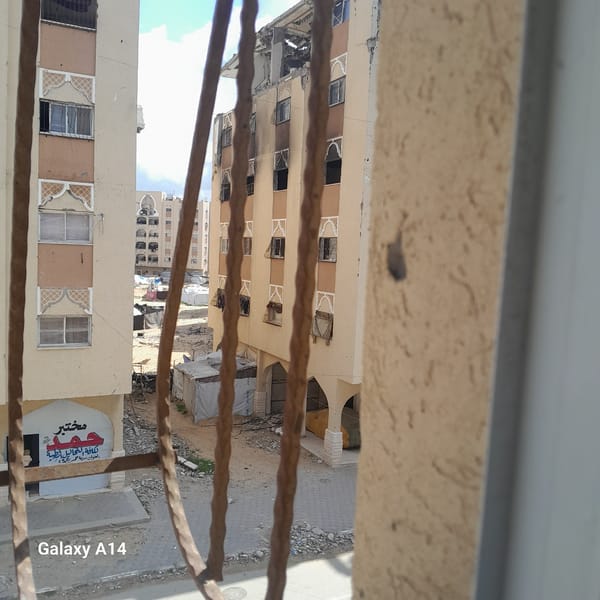 Elevated urban view shows varied architecture, possible damage