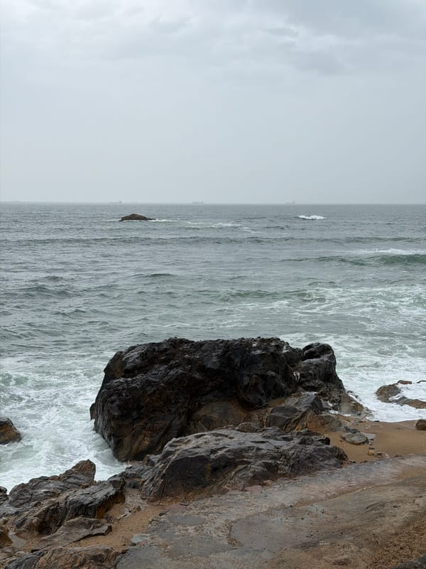 Turbulent waves batter Porto coastline under overcast skies