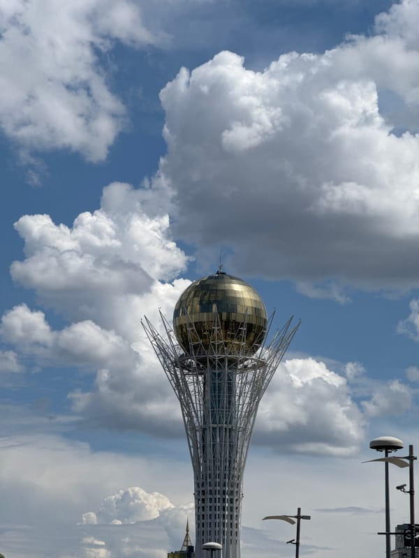 Bayterek Tower and Astana streets on a cloudy morning