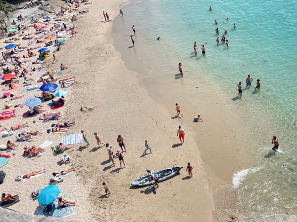 Packed summer beach day in A Coruña, Spain
