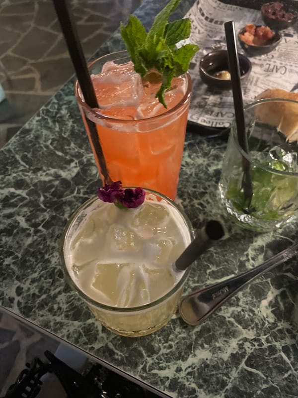 Three drinks served on marble table in Herzliya