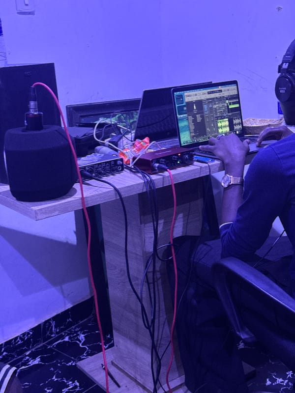 Late-night recording session captured in blue-lit Abuja studio