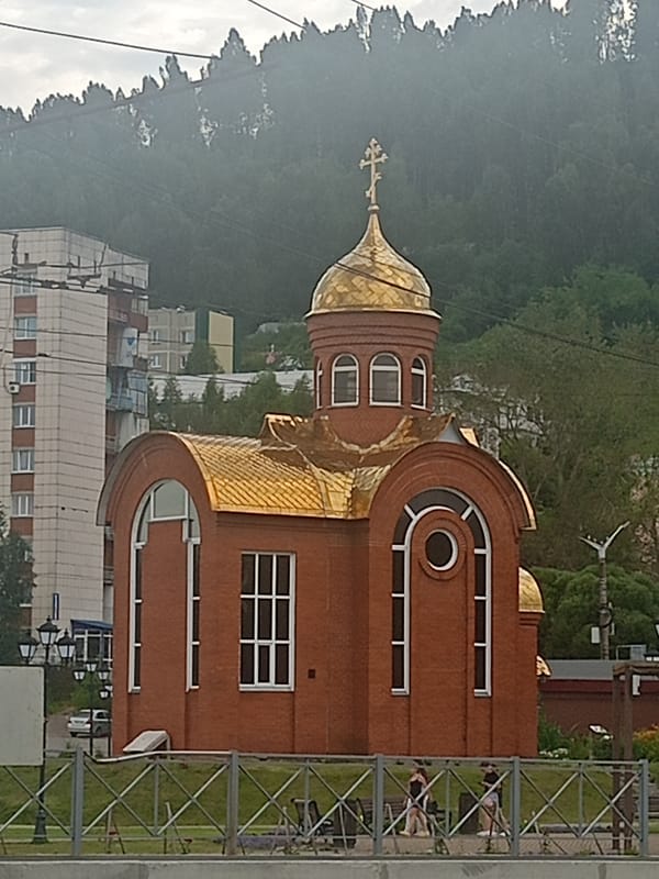 Church, cliffs, and trail signage in Zlatoust, Russia