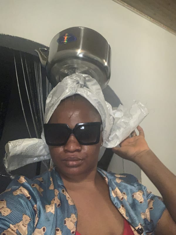 Person in teddy bear shirt, baby photographed indoors Nigeria