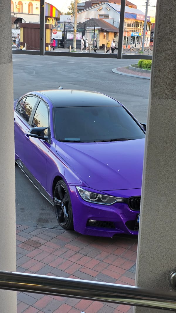 Purple BMW parked on brick plaza in Vinnytsia