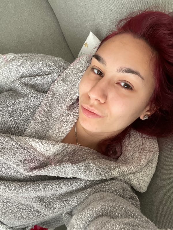 Woman rests on couch in Bulgarian home