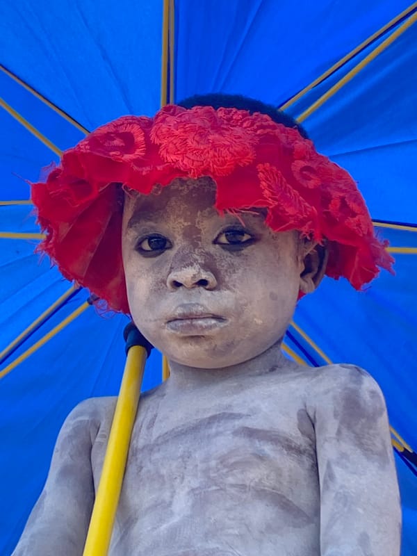 Child statue with red covering documented in Amancho, Nigeria