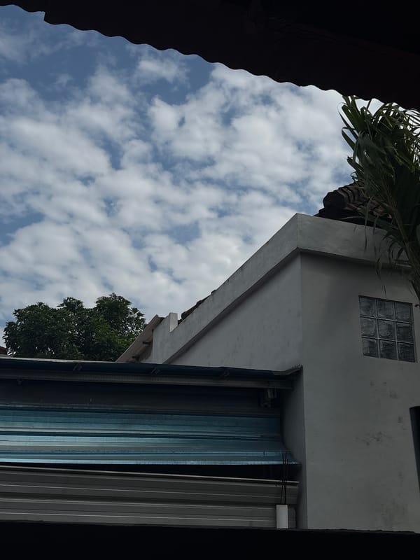 Rooftops and sky over a Denpasar neighborhood