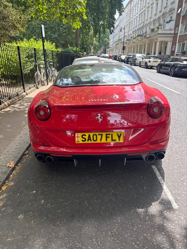 Red Ferrari California parked on a London terraced street