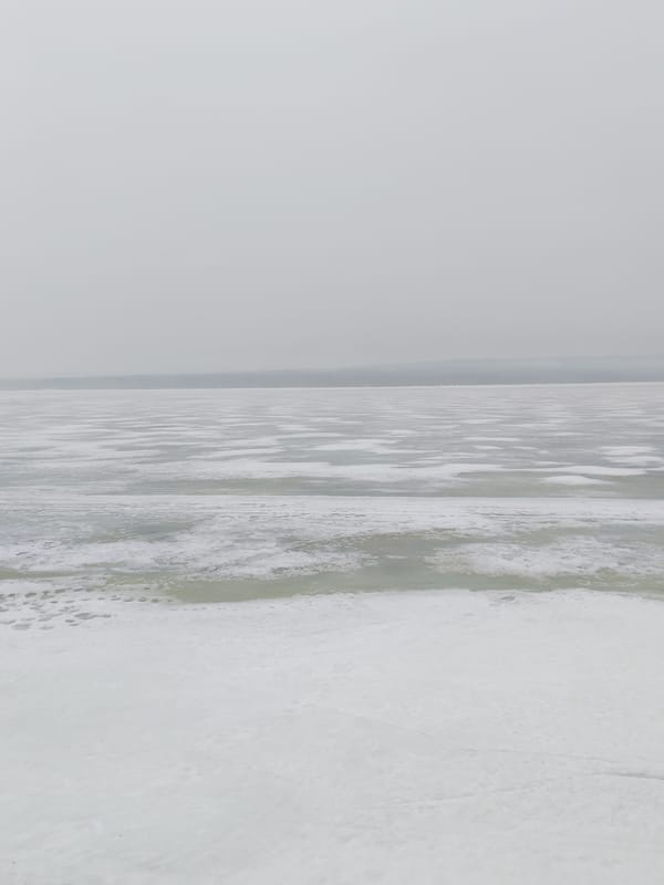 Spring scenes captured in Chaikovsky: frozen river, outdoor chess table