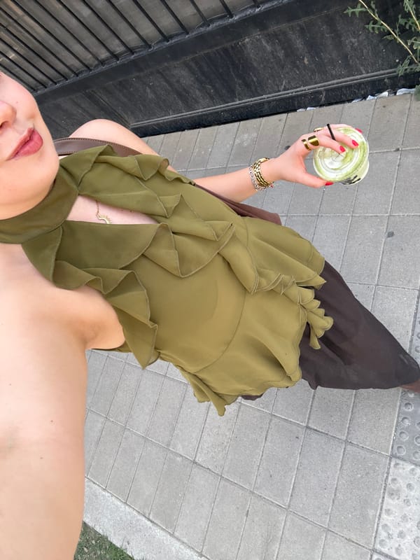 Person enjoys matcha and books during cultural space visit