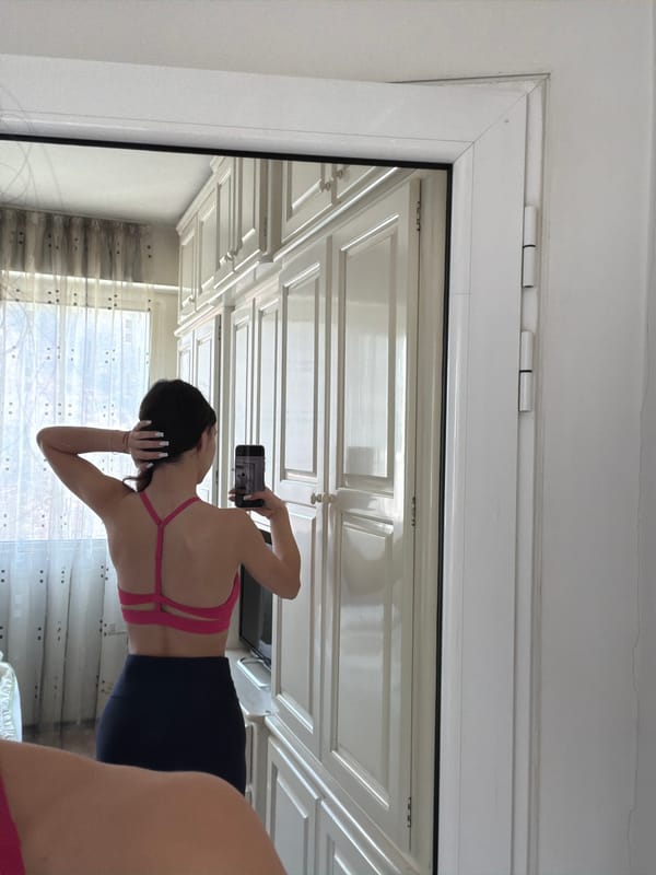 Woman takes mirror selfie in athletic wear in Gabrovo