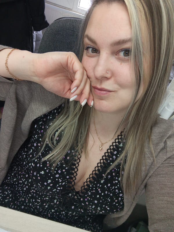 Woman takes morning selfies in Russian office setting